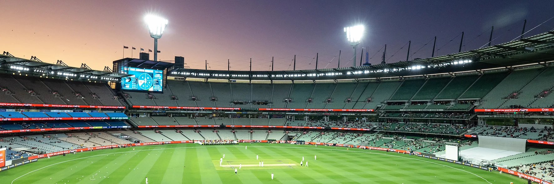 MCG cricket match beneath twilight sky