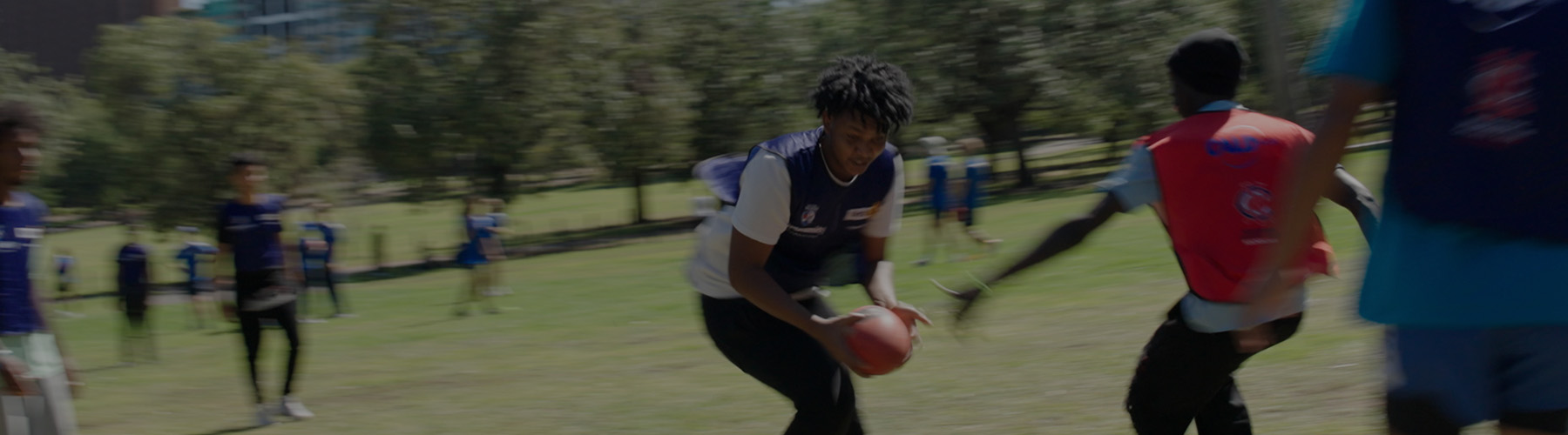 CALDplay students play AFL football in Yarra Park