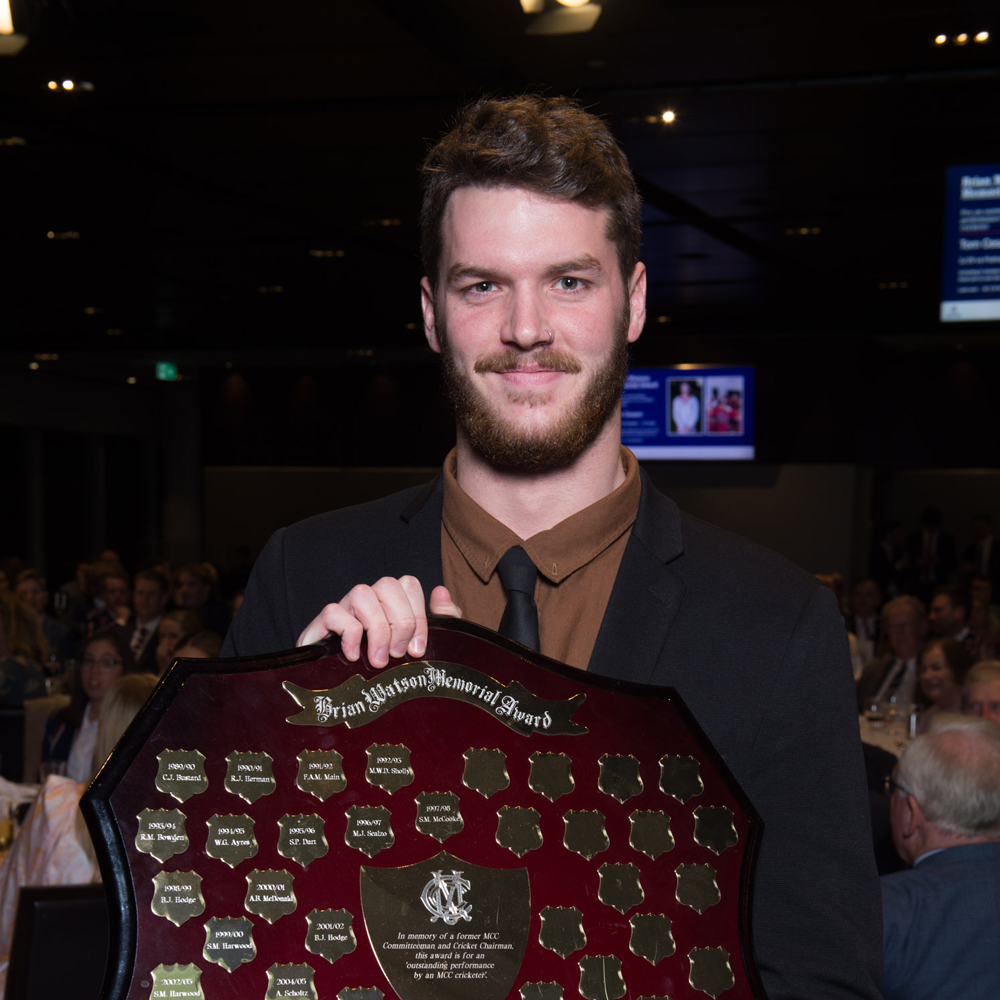 A man holds a trophy that he has won