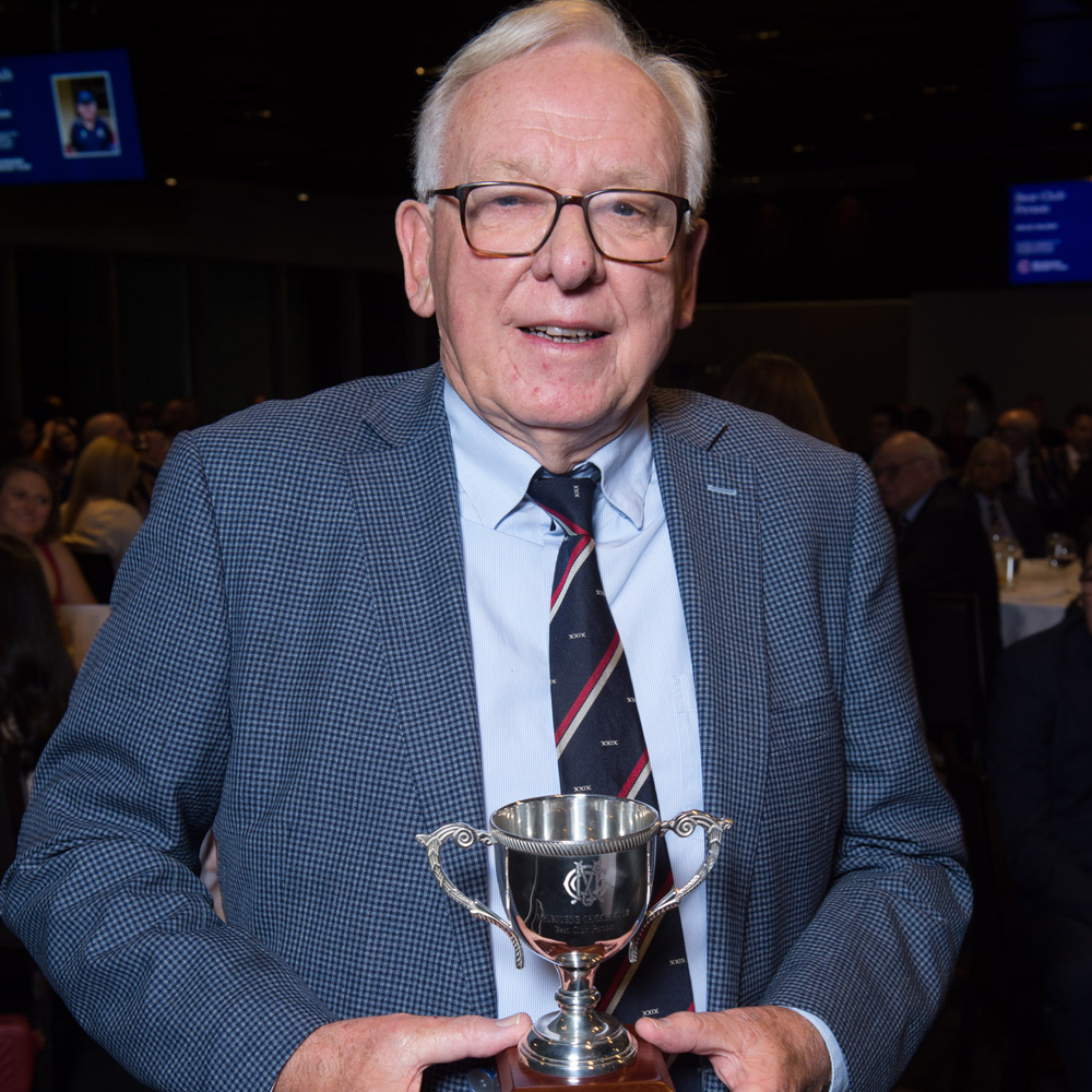 A man holds a trophy that he has won