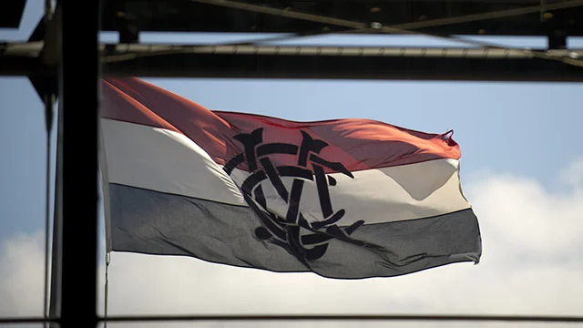 Red, white and black flag with MCC logo