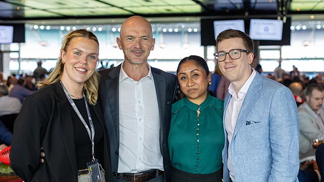 Four people in attire that meets the MCC dress standard with collared shirts or blouses