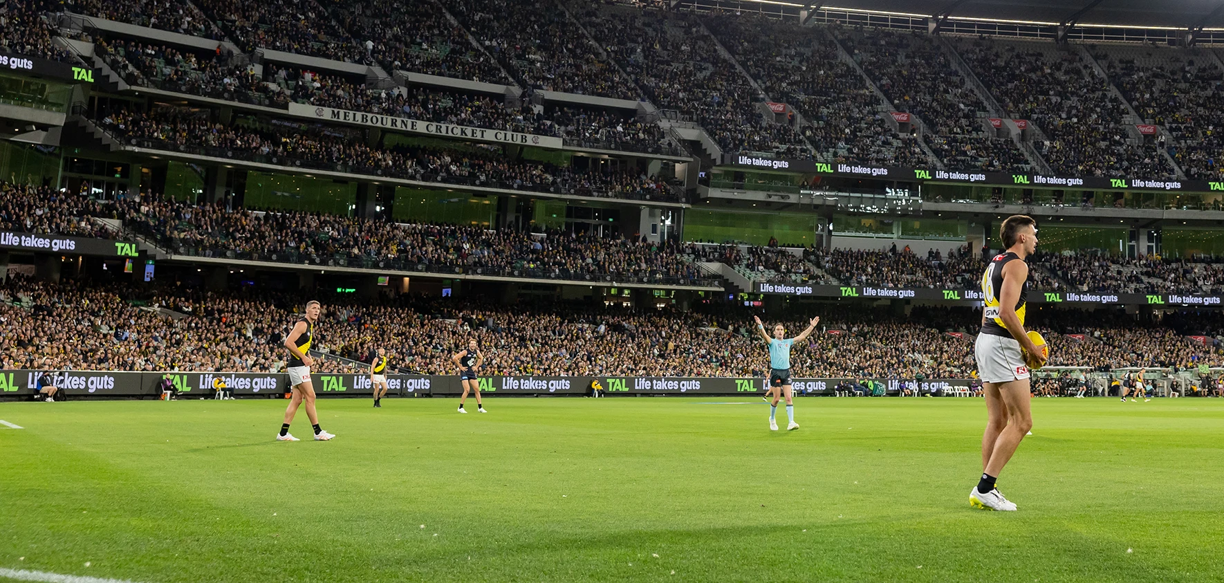 Richmond players on the MCG during a night match