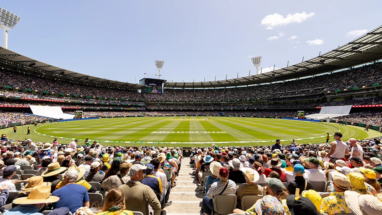 Packed crowd at the MCG for cricket on a sunny day