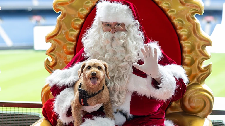 Santa poses with puppy at the MCG