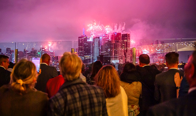 Crowd watching fireworks over the Melbourne city skyline